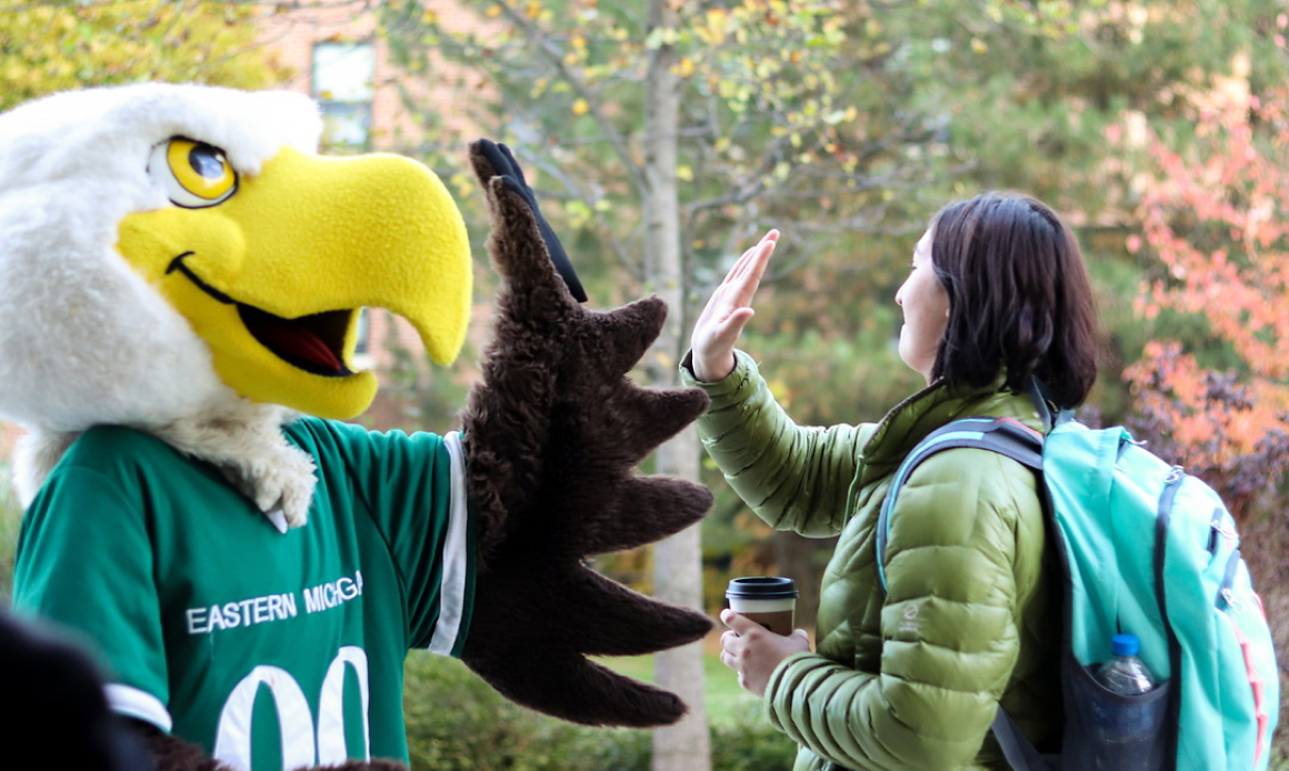 student and mascot high five