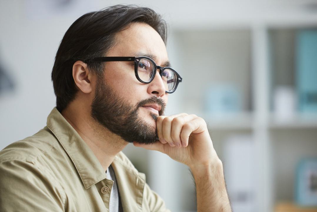 A man thinking about the future of going back to college. ReUp supports learners like him